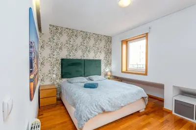 a bedroom with a large bed and a window at Cedofeita Exclusive with parking included in Porto