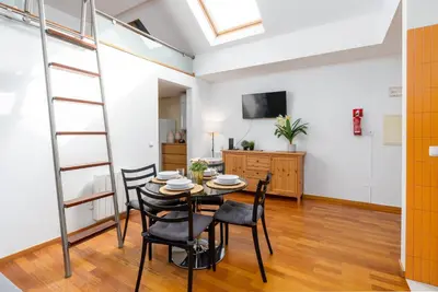 a dining room with a table and chairs at Cedofeita Exclusive with parking included in Porto