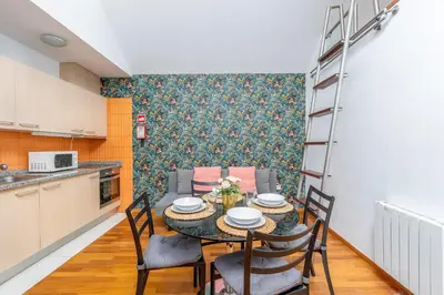 a kitchen and dining room with a table and chairs at Cedofeita Exclusive with parking included in Porto