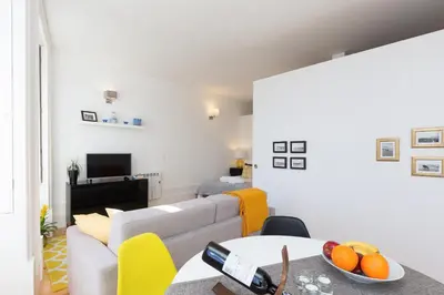 a living room with a couch and a table at Host Wise - Colorful Stunning Sunlit Flat in Porto