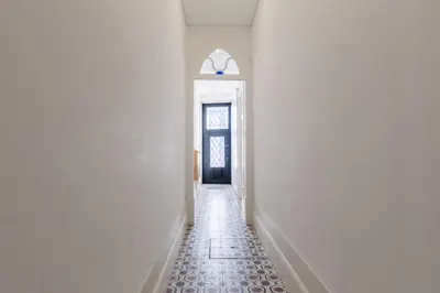 a hallway with a blue door and a tile floor at Host Wise - Colorful Stunning Sunlit Flat in Porto