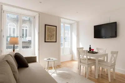 a living room with a table and a dining room at Casa do Poeta in Porto