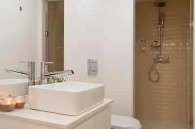 a bathroom sink with two candles on a counter at Casa do Poeta in Porto
