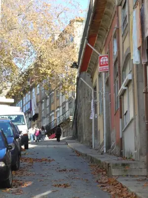 a street with cars parked on the side of a building at Oportobestview-TopFlat in Porto