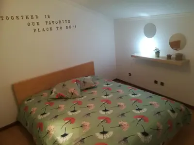 a bed with a comforter with umbrellas on it at Oportobestview-TopFlat in Porto