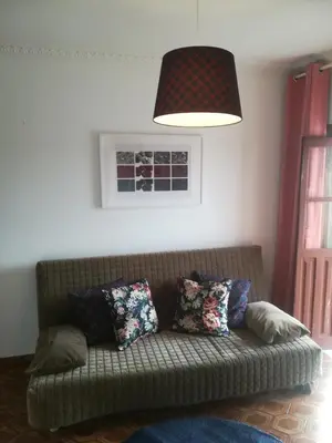 a couch with pillows in a living room with a lamp at Oportobestview-TopFlat in Porto