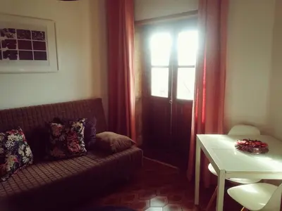 a living room with a couch and a window at Oportobestview-TopFlat in Porto