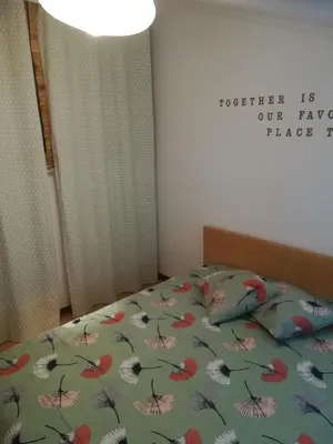 a bedroom with a bed with a floral comforter at Oportobestview-TopFlat in Porto