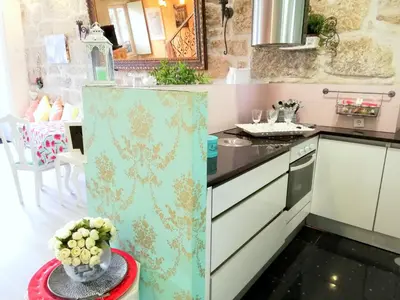 a kitchen with a refrigerator and a table with flowers at Cor Iesu House, Arts Quarter, Porto in Porto