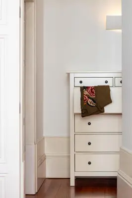 a white chest of drawers in a room at LovelyStay - Aurora Heights Apartment in Porto