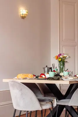 a dining room table with chairs and a table with food at LovelyStay - Aurora Heights Apartment in Porto