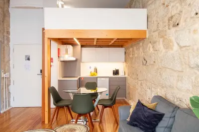 a kitchen and living room with a table and chairs at LovelyStay - Aurora Mezzanine in Porto
