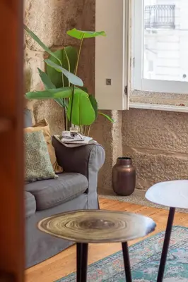 a living room with a couch and a potted plant at LovelyStay - Aurora Mezzanine in Porto