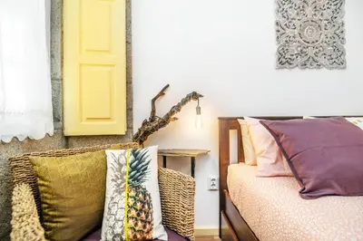 a room with pillows on a bed and a yellow door at Casa Sá Noronha Old Town in Porto
