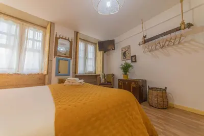 a bedroom with a large bed with a yellow blanket at Casa Sá Noronha Old Town in Porto