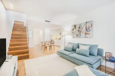 a living room with a blue couch and a tv at Porto City Elegant Retreat in Porto