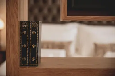 a book sitting on top of a wooden shelf at viterbo'8 - The Artists House in Porto