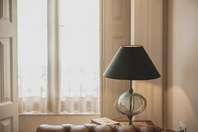 a lamp sitting on a table next to a couch at viterbo'8 - The Artists House in Porto