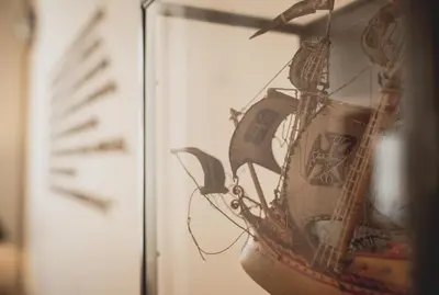 a close up of a model ship in a mirror at viterbo'8 - The Artists House in Porto