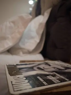 a book sitting on a table next to a bed at SP199 Flat by in Porto