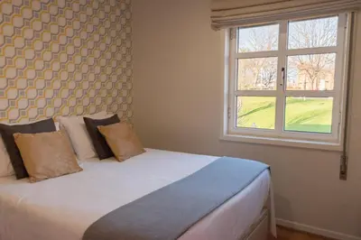 a bedroom with a bed with a window at North Star Flats @ Dom Luís I Bridge in Vila Nova de Gaia