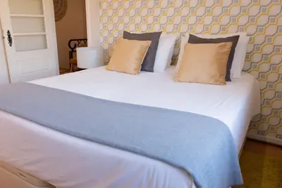 a bedroom with a large white bed with pillows at North Star Flats @ Dom Luís I Bridge in Vila Nova de Gaia