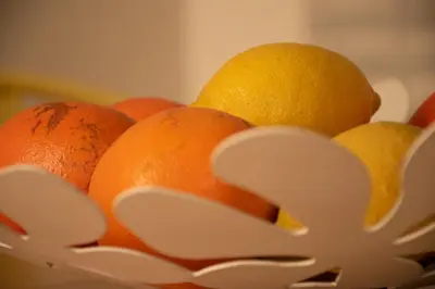 a bowl of oranges and lemons in a bowl at North Star Flats @ Dom Luís I Bridge in Vila Nova de Gaia