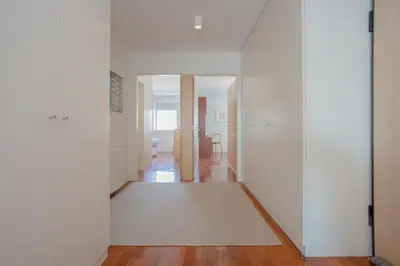 a hallway with white walls and a rug on the floor at Liiiving in Porto | Bright Light Apartment in Porto