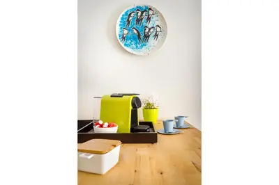 a living room with a yellow heater and a plate on the wall at Exquisite Retreat in a Traditional Area of Porto in Porto