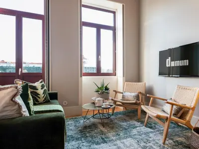 a living room with two chairs and a table at Domum 3 in Porto