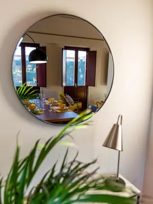 a mirror reflecting a living room with a dining table at Domum 3 in Porto