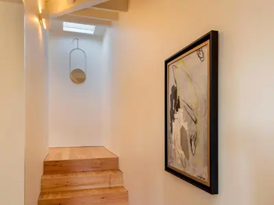 a staircase with a painting and a picture on the wall at Domum 3 in Porto