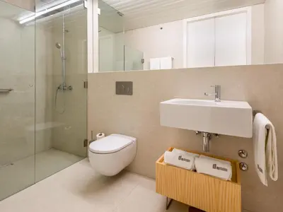 a bathroom with a toilet and a sink and a shower at Domum 3 in Porto