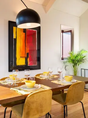a dining room with a wooden table and chairs at Domum 3 in Porto