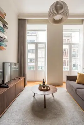 a living room with a couch and a coffee table at Lit Apartments - SÁ DA BANDEIRA in Porto