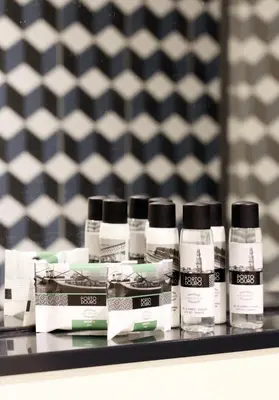 a shelf with four bottles of hair products on it at HM - Ribeira São João 2E in Porto