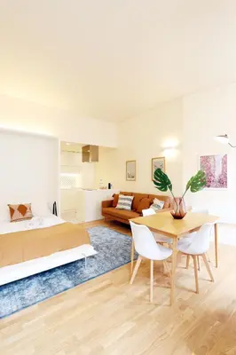 a bedroom with a bed and a table and a couch at HM - Ribeira São João 2E in Porto