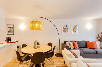 a living room with a couch and a table at Almada Luxurious Duplex by DA'HOME in Porto