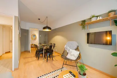 a dining room and living room with a table and chairs at DA'HOME - Marquês Lovely 2BD Apartment in Porto