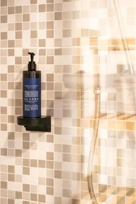 a soap dispenser on a tiled shower wall at DA'HOME - Marquês Lovely 2BD Apartment in Porto