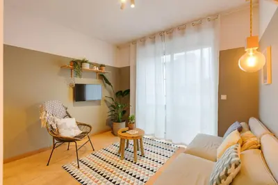 a living room with a couch and a chair at DA'HOME - Marquês Lovely 2BD Apartment in Porto