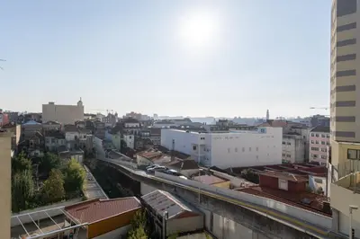 a view of a city with buildings and a train at Cozy Apartment Alegria Balcony in Porto