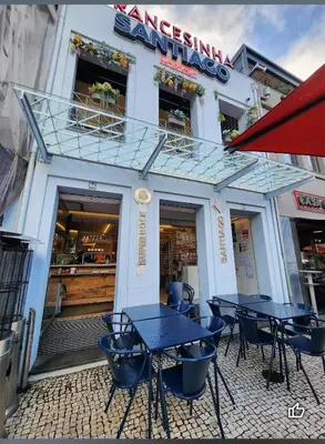 a group of tables outside of a restaurant at Cozy Apartment Alegria Balcony in Porto