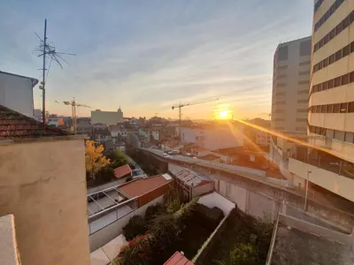 a view of a city at sunset from a building at Cozy Apartment Alegria Balcony in Porto