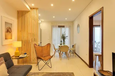 a bedroom with a bed with a mirror and a window at DA'HOME - Marquês Unique Terraza in Porto