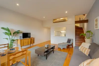 a living room with a couch and a table at DA'HOME - Vitoria Duplex Apartment in Porto