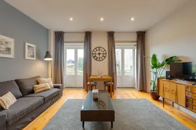 a living room with a couch and a coffee table at DA'HOME - Vitoria Duplex Apartment in Porto