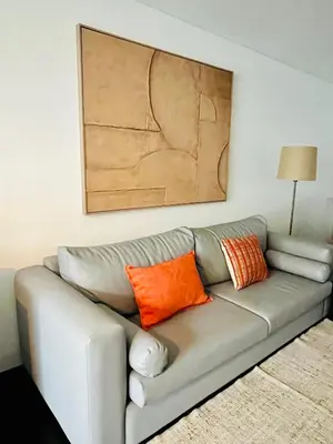 a living room with a gray couch with orange pillows at PATEO LUSO - Cozy Apartment City Center in Porto