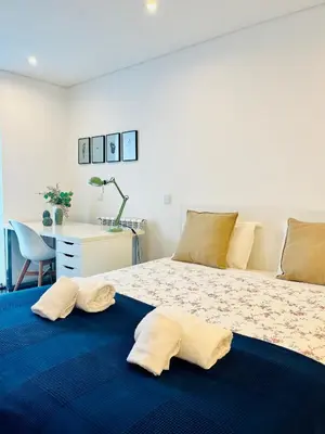 a bedroom with a bed with two pillows on it at PATEO LUSO - Cozy Apartment City Center in Porto
