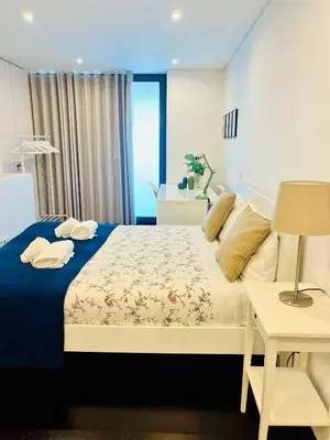 a bedroom with a king sized bed with a blue blanket at PATEO LUSO - Cozy Apartment City Center in Porto
